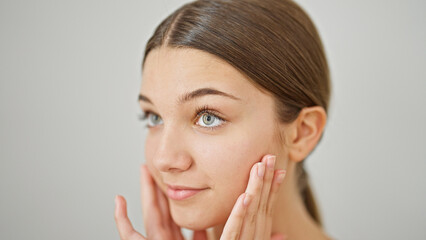 Poster - Young beautiful girl massaging face over isolated white background