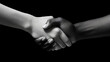 © Tech Hendra - Handshake between black and white people on dark background.