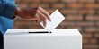 Man's hand putting white envelope into ballot box. Unrecognizable person exercising the right to vote.