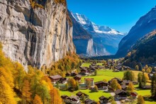 Idyllic Scenery: Lauterbrunnen Village Basks In Sunny Autumn With Magnificent Staubbach Waterfall & Swiss Alps As Backdrop. Famous Swiss Site. Generative AI
