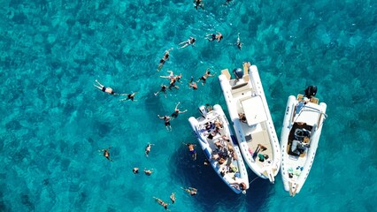 Wall Mural - Aerial view of a group of friends playing on the water, Sardinia, Italy 