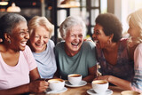 Fototapeta  - Happy smiling middle aged female friends sitting in a café laughing and giving support each other. They are celebrate a long friendship
