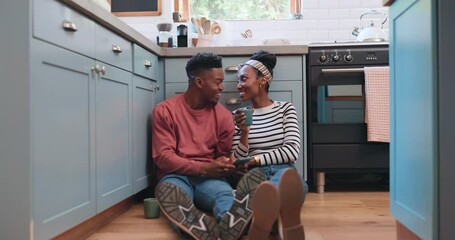 Poster - Phone, floor and couple in kitchen for conversation, bonding and healthy relationship in home. Dating, love and black man and woman sitting on smartphone for social media, internet and online website