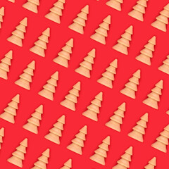 Wall Mural - Christmas tree wooden ornaments on red background diagonal layout. Eco friendly decoration abstract pattern for Merry Christmas Noel Yule greeting card, wrapping paper.