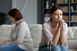 © fizkes - Frustrated adult daughter seated on couch with middle-aged sad mother women not looking talking after quarrel, concept of different opinions and outlook on life, generational gap, spoiled relations