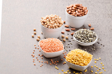 Wall Mural - Assorted uncooked gram and lentils on table