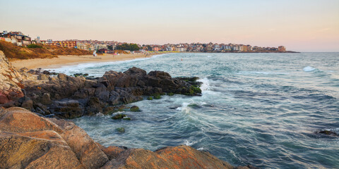Wall Mural - sea washing the coast of sozopol. town behnid the beach in the distance. recreation and summer holid