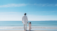 A Father Holding A Daughter's Hand. Standing In Front Of The Beach With Clear Blue Sky.