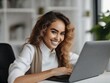 © Евгений Порохин - a young smiling beautiful woman is working at a laptop in the office