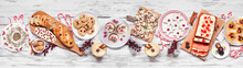 Christmas Food Table Scene. Top Down View On A White Wood Banner Background. Selection Of Appetizers And Delicious Sweets. Copy Space. Holiday Party Food Concept.