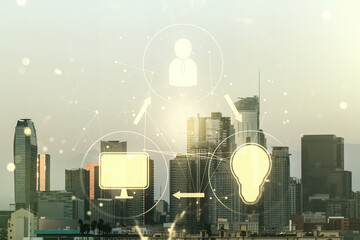 Double exposure of social network icons hologram on Los Angeles office buildings background. Networking concept