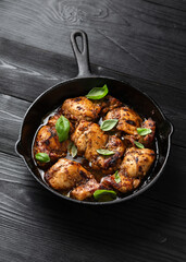Wall Mural - Baked balsamic chicken thighs in cast iron pan