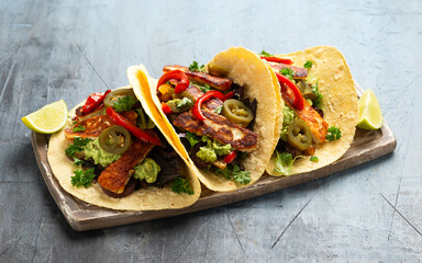 Wall Mural - Fried halloumi fajitas with pan roasted onions and bell peppers, avocado guacamole and pickled jalapeno peppers