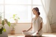 Asian woman yoga pose at home sitting