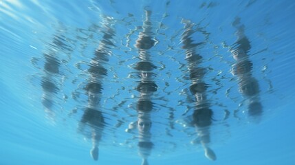 Wall Mural - A synchronized swimming team in perfect unison, forming intricate patterns beneath crystal-clear water.