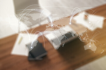 Double exposure of abstract digital world map with connections and modern desktop with laptop on background, research and strategy concept