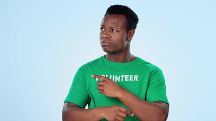 Canvas Print - Face, volunteer and black man with opportunity, pointing and presentation on a blue studio background. Portrait, African person and model with gesture, promotion or choice with charity worker and ngo