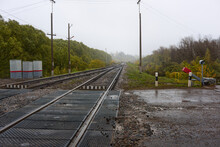 Railway Crossing With Rubber Cord Flooring. Rails Going Into The Foggy Distance. Rubber Crossing System.