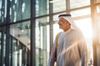 © VisualProduction - Successful mature arab man walking in business building with documents in hand. Confident black business man in business environment building