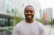 Happy african american man smiling outdoor. Portrait of young happy man on street in city. Cheerful joyful handsome person guy looking at camera. Freedom happiness carefree happy people concept