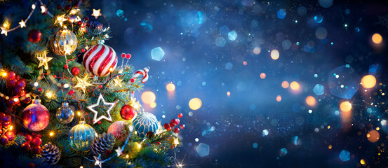 Wall Mural - christmas tree with ornaments in blue and bokeh lights - real fir branches with glittering in abstra