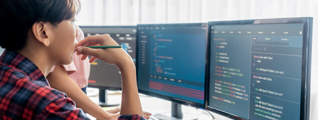 Cropped image of professional programer team collaboration discuss about web coding while coworker point java script displayed on computer at modern company office. Closeup. Burgeoning.