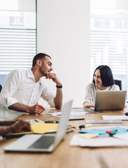 Sticker - Coworkers smiling and talking during business meeting