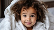  a very cute little black african baby kid with afro hair wrapped in soft white blanket on a bed smiling. image perfect for ads. big beautiful eyes and tiny nose. Generative AI
