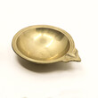 a traditional vintage diwali oil diya lamp in gold used for decorating festival and celebrations isolated in a white background