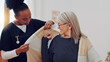 © Wesley JvR/peopleimages.com - Senior woman, nurse and help with clothes, smile and care in retirement, nursing home and support. African caregiver, elderly lady and happy with getting dressed with assisted living, love and house