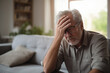 © toonsteb - Sick old man having a headache in the living room during the daytime
