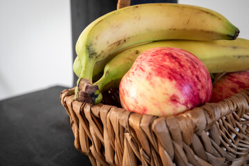 Wall Mural - Red apples and bananas in a wicker basket. Fresh fruit