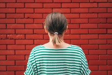 Dead End Concept, Rear View Of Casual Brunette Female Facing The Red Brick Wall