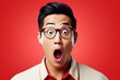 Portrait of surprised asian man on bright colors studio backgroud, excitement and fascination, shocked and amazed male with unexpected thing happen