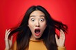 Portrait of surprised asian woman on bright colors studio backgroud, excitement and fascination, shocked and amazed female with unexpected thing happen
