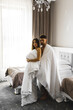 © Darius - Couple in love posing in blankets in a hotel room in the mountains. Concept for a vacation in the mountains