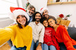 © Xavier Lorenzo - Happy family taking selfie portrait celebrating christmas together at home. Celebration and xmas concept.