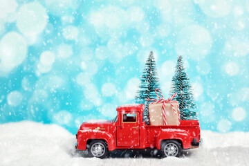 Wall Mural - Red toy pickup truck with a gift. Merry Christmas and New Year greetings, boxing day, delivery.