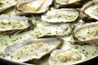 close-up of grill marks on oysters with garlic sauce