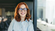 © Jacob Lund - Successful businesswoman in glasses smiling at her workplace