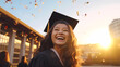 A portrait of beautiful Asian teenage girl in graduation gown on her graduation day smiling happily and looking at the sky. Education and people.