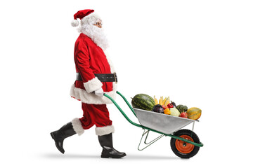 Wall Mural - Santa claus walking and pushing fruits and vegetables in a wheelbarrow