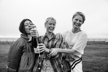 Girlfriends Popping A Champagne Bottle In Celebration