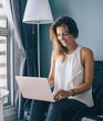 © BullRun - happy woman playing online games via modern netbook during leisure in own apartment