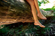© ADDICTIVE STOCK - Crop preteen girl with crossed legs and barefoot on tree trunk in nature