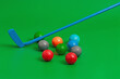 Colorful golf balls placed on green surface