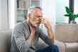 © brizmaker - sick mature man feeling headache and acute pain in throat