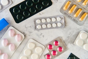 Wall Mural - Pills capsules medicine health on light background top view, medical pharmacy concept. Different pills on light background with copy space.