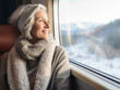 © kalafoto - The old woman sat on the train looking out of the window