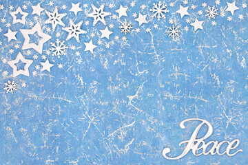 Wall Mural - Peace on earth at Christmas abstract background on mottled blue with star and snowflake decorations. Festive happy holidays, New Year, Noel, winter theme.